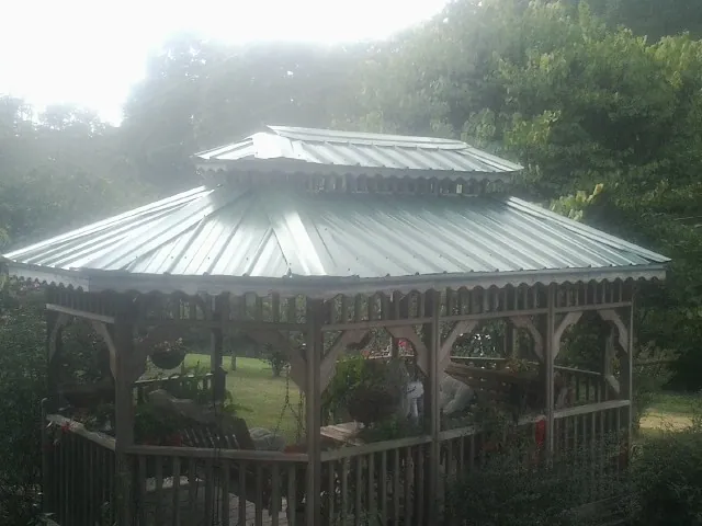 Two tier green metal roof on a garden gazebo in Benton
